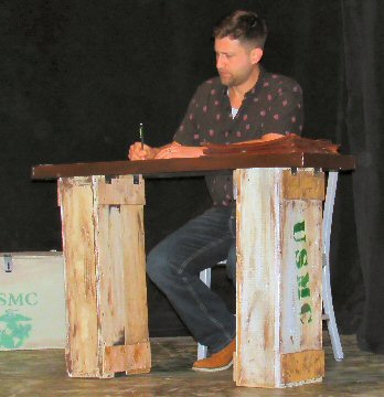 a man sitting at a makeshift desk