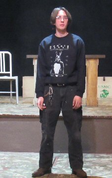 a man stands in front of the stage